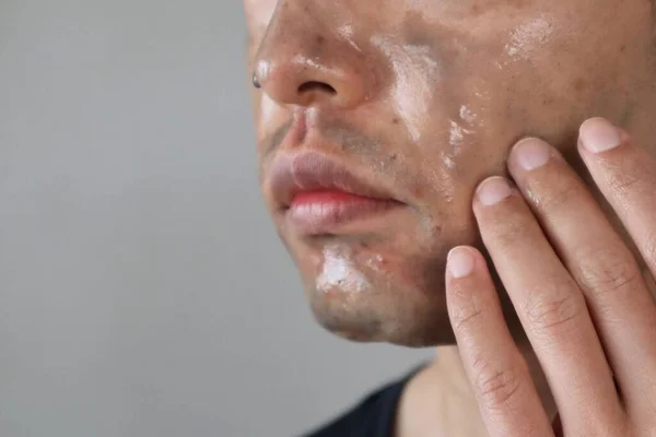 Close-up of a man washing his face