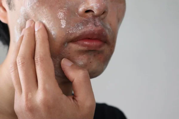 Close-up of a man washing his face