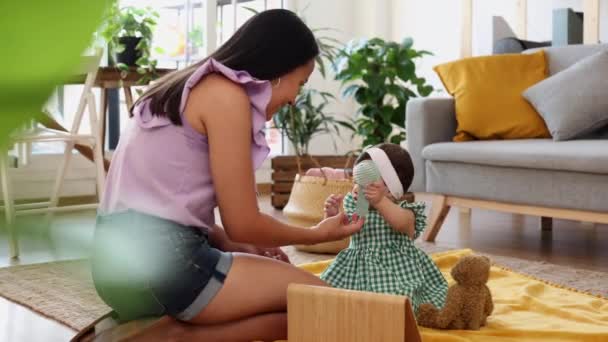 Latinalainen Äiti Istuu Yksin Olohuoneessaan Tekemässä Hiuksiaan Leikkimässä Vauvansa Kanssa — kuvapankkivideo