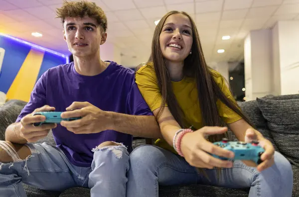 sister and brother gamers playing game console while having fun
