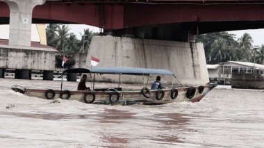 Palembang, Endonezya - 30 Mayıs 2024: Musi Nehri 'nde mal taşıyan tekneler. Güney Sumatra, Endonezya 'daki Palembang şehrindeki ünlü nehir..