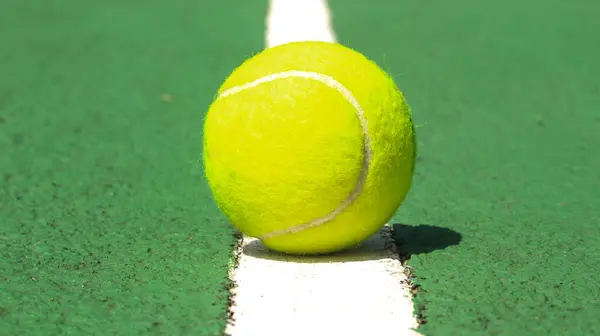 stock image Tennis ball on blue tennis court. the concept of a sporty lifestyle.