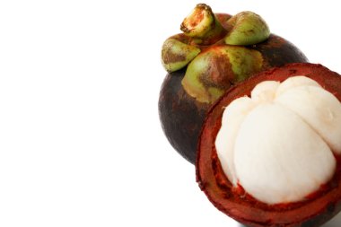 Manggis (Garcinia mangostana L), taze olgun mangosteen meyveleri ve kalın mor deri ve beyaz eti gösteren kesit.