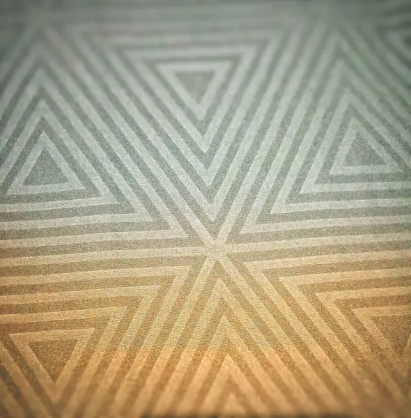 stock image The design used for the Koko Shirt, or the triangular symbol. Textured triangle, coloured.