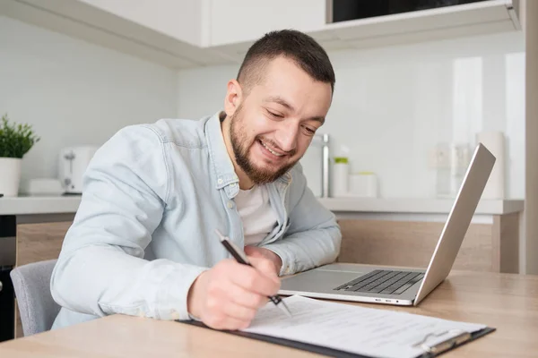 Young Man Watching Educational Webinar Lecture Computer Writing Notes Paper — Stock Photo, Image