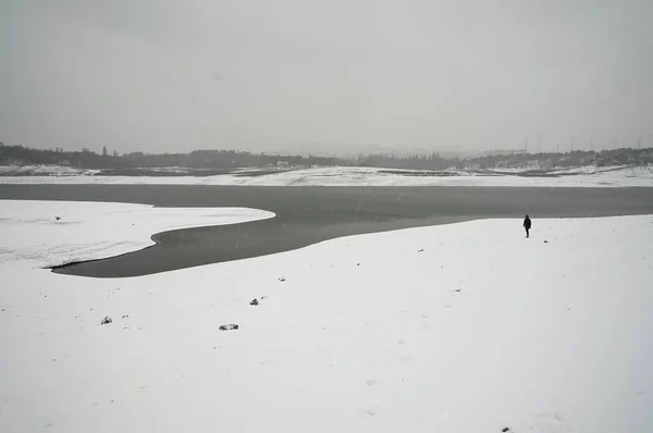 Lonely Man Stands Snow Covered River Bank Snowy Winter Day — Stock Photo, Image
