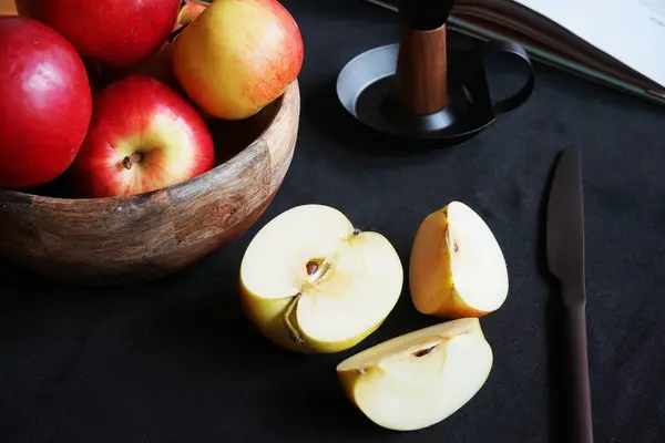 Cut Apple Next Other Apples Book Candlestick Knife Black Background — Stock Photo, Image