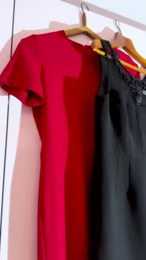 Askıda kırmızı ve siyah elbiseler