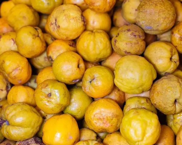 Fresh ripe yellow quince. Fruits in a wooden box. Top view. Free space for text. High quality photo