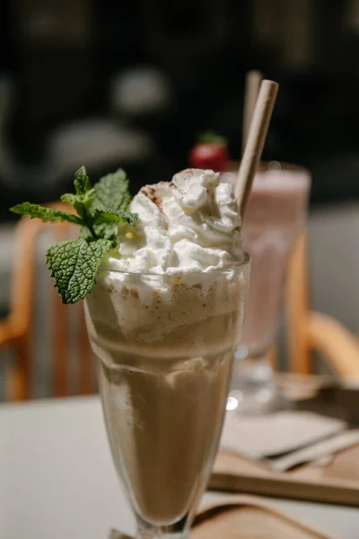 A frozen cappuccino is the best coffee option, when the temperatures are too high for a warm drink! This one was served with whipped cream, mint leaves and a straw. Perfect subject for a detail photo shot with only the drink in focus!