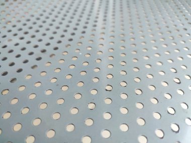 Perforated white metal panel background. White metal plate with dots. Aluminum punching metal clipart
