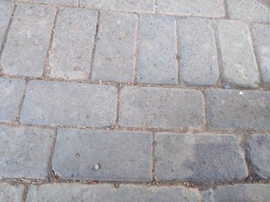 Street of full frame rectangular paving bricks in urban environment clipart