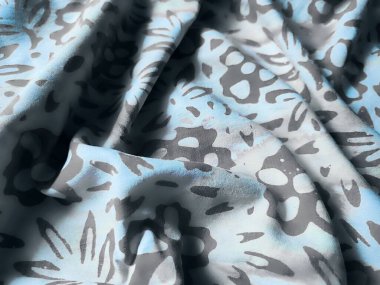 Kumaş, çiçekli motiflerin orta tonlarda yoğun bir düzeniyle desenlenmiş.