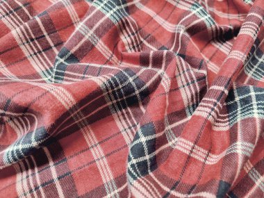 The pattern and background of the fabric has a red checkered motif clipart