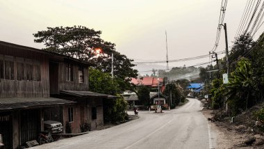 Eski ahşap evleri ve elektrik hatları olan bir cadde. Tayland ve kırsal kesimde