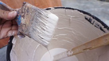 Evde beyaz bir duvar resmi üzerine el fırçası