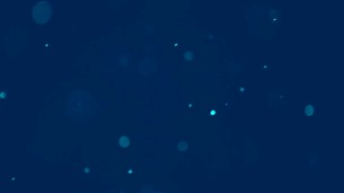 Toz, daireler, bokeh etkisi mavi arka planda rastgele farklı yönlere hareket ediyor, soyut.