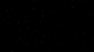 Uzay uçuş efekti, uçan sarı toz parçacıkları, siyah arkaplan, soyut.