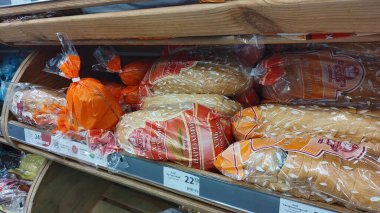 Dnipro, Ukrayna - 26 Nisan 2025 - marketin rafında çeşitli paketlenmiş taze ekmek somunları sergilenmektedir. Gıda seçimi konsepti, günlük ihtiyaçlar ve süpermarket alışverişi.