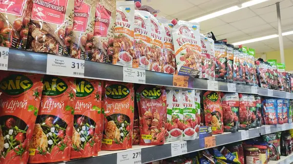 Dnipro, Ukrayna - 26 Nisan 2025 - Süpermarket raflarında sergilenen farklı aroma ve markalarda çeşitli ketçap paketleri. Market alışverişi, domates sosu seçimi, gıda baharat ürünleri..
