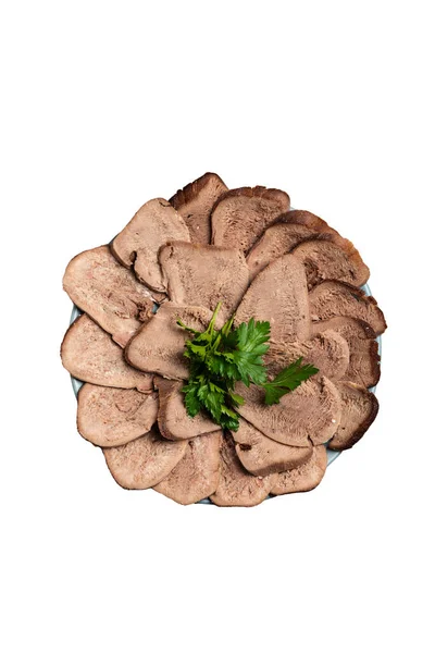 Boiled beef tongue with greens and mustard on a plate. Top view isolated background.