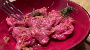 Exclusive red beetroot dumplings in a beautiful clay plate. High quality 4k footage