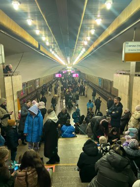 Kyiv , Ukraine - October 2022: A crowd of local residents of Kyiv hide in the subway bomb shelter during air raids. Russias war against Ukraine. clipart