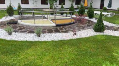 Kneipp stepping pools walking in spa wellness resort at rainy day.