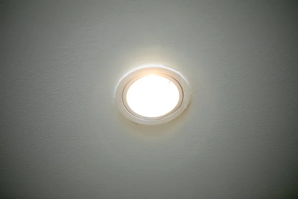 Light bulbs mounted on the ceiling with a white background. Close-up.