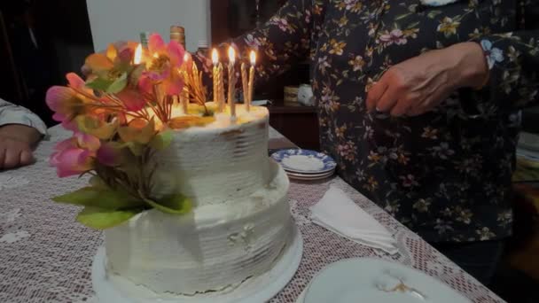 Older Woman Blowing Out Candles Her Birthday Cake — Stock Video