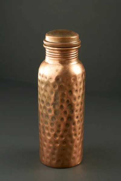 Hammered Copper Bottle on Gray Background