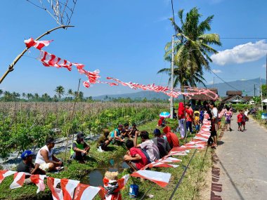 Magelang, Indonesia - August 15, 2021 : photo of many people on the river taking part in a fishing competition on the occasion of Indonesian independence day