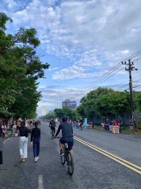 Solo, Indonesia - October 22, 2022 : photo of the morning atmosphere at the car free day event. people walking and cycling