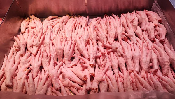 Fresh chicken foot in the markets, a close up of a pile of raw chicken feet