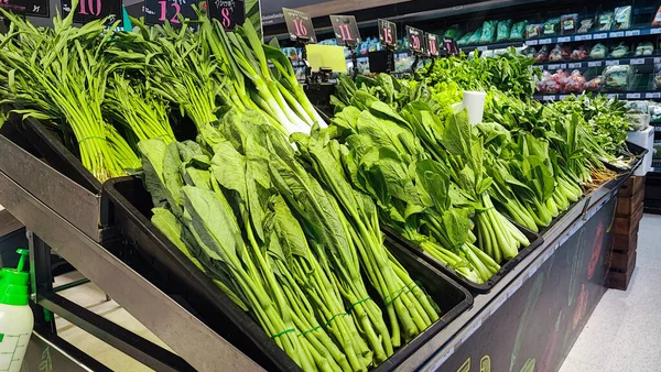 fresh green vegetable on shelf in grocery store for sale