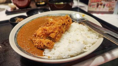 Crispy fried pork cutlet with curry and rice, Japanese food style clipart