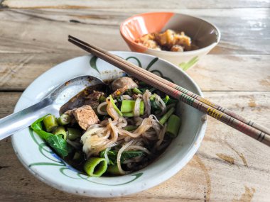 Boat Noodles Namtok Thai food, thin beef noodles, and fried pork rinds as a side dish, clipart