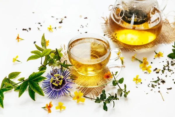Calming herbal tea with the leaves of the passion flower on white background
