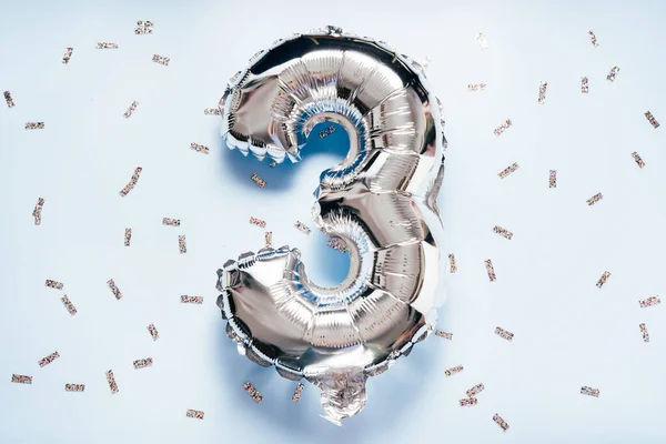 Silber balloon number 3 on light glitter background for your desing
