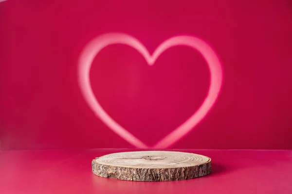 Valentines Day minimalistic compisition with wood podium saw cut of tree on vivid magenta background. Concept scene stage showcase, product. Trendy color 2023