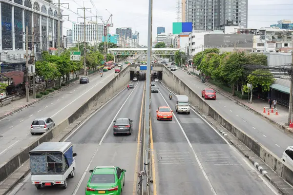 Image of traffic on a road running back and forth in a city in Bangkok. Thailand during daytime It\'s a bird\'s-eye view of every road. and a tunnel for cars to pass under the bridge.