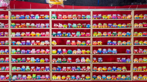 Picture of a game booth at a temple fair. This game will allow players to shoot airsoft guns. to work with small dolls The ones that lined the shelves fell down. If you shoot and fall You\'ll get a dol