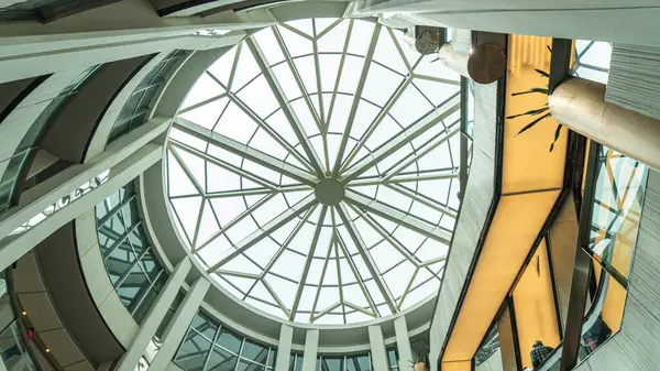 Image of a geometric circular skylight dome with glass to let light in. and decorate the weight-bearing beams into geometric shapes that is strangely beautiful
