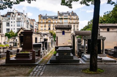 Paris, Fransa 'daki ikonik Montparnasse Mezarlığı' nın sakin manzarası. Tarihi mezar taşları ve huzurlu bir ortam..