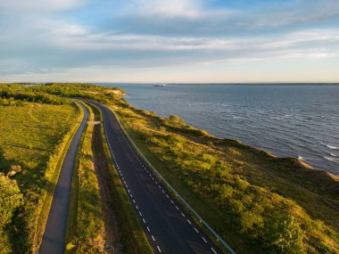 Road near a cliff in Paldiski at sunset in summer. High quality photo