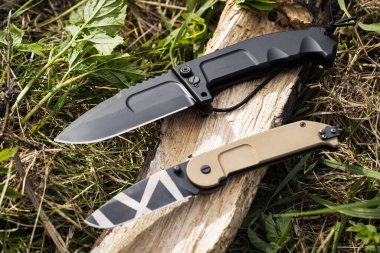 Tactical knives in nature for a summer camp, close-up photo. High quality photo