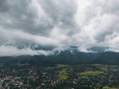 Drone view of the Polish city of Zakopane and the Tatra mountains, the sky is covered with clouds, cloudy weather. High quality photo.