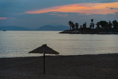 Umbrella on a Athens beach near Athens at sunset. High quality photo