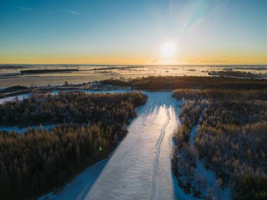 Estonian nature in winter early in the morning, the sun rises over the frozen Maardu quarry, above view. High quality photo