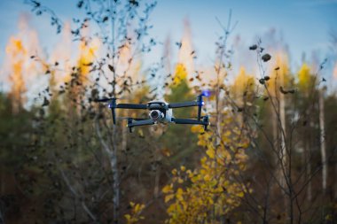 Drone with camera in the air in nature in autumn. High quality photo